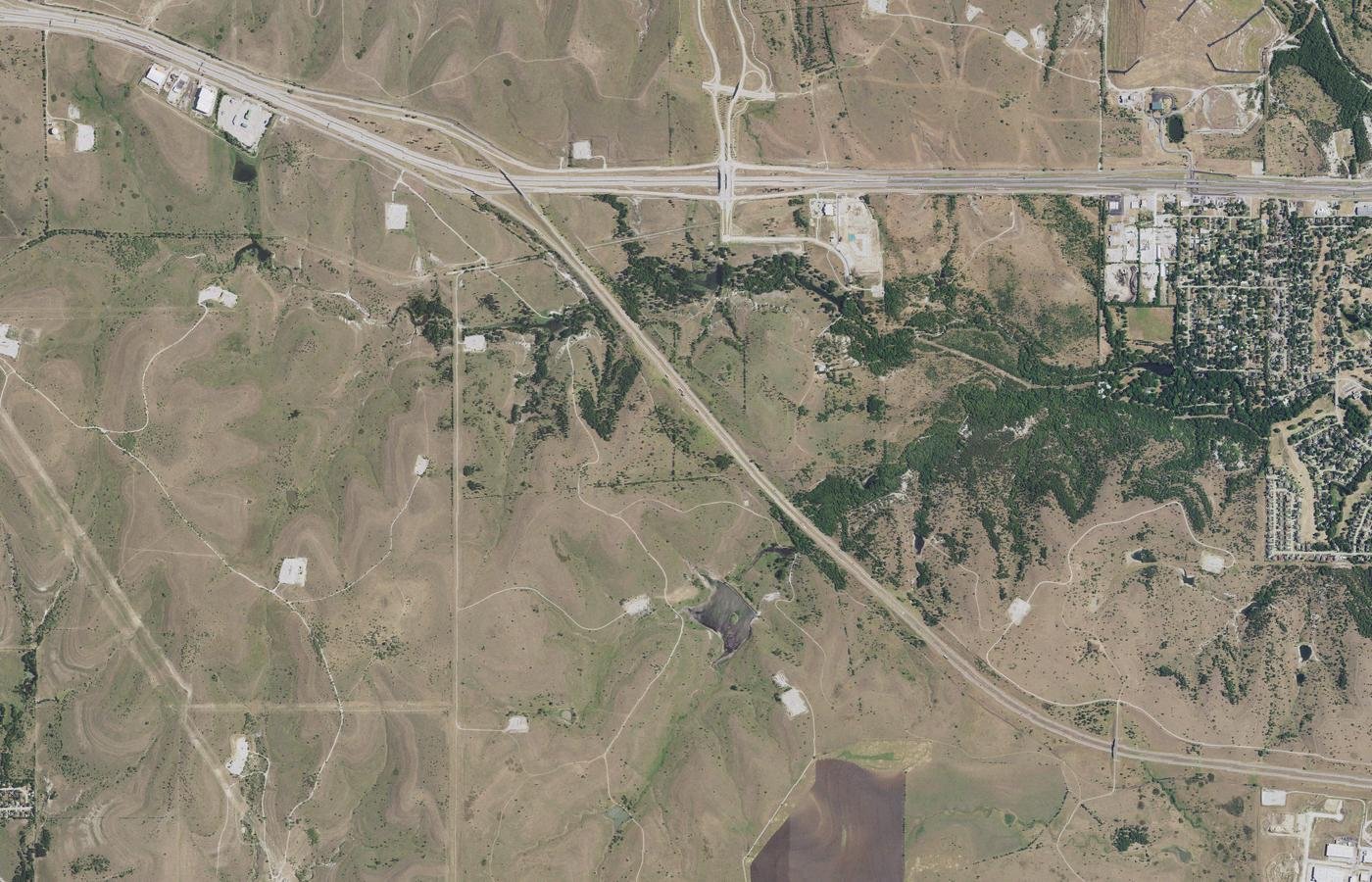 Aerial photograph of the Walsh development along Walsh Ranch Parkway, Fort Worth, Texas: streets, homes and open pasture.